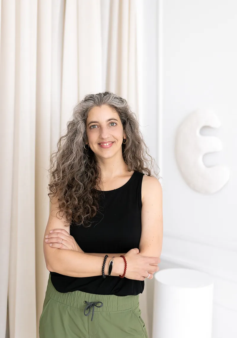 Photo of Emily Sadowski smiling with arms crossed near hips